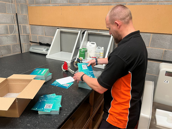 Team member Gary instpecting the quality of printed greetings cards before delivery.