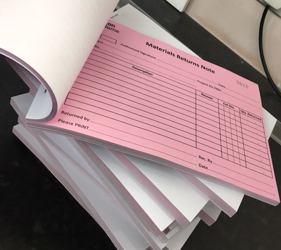 Image of pink NCR pads used for materials return notes, printed by The Print Room, Bolton